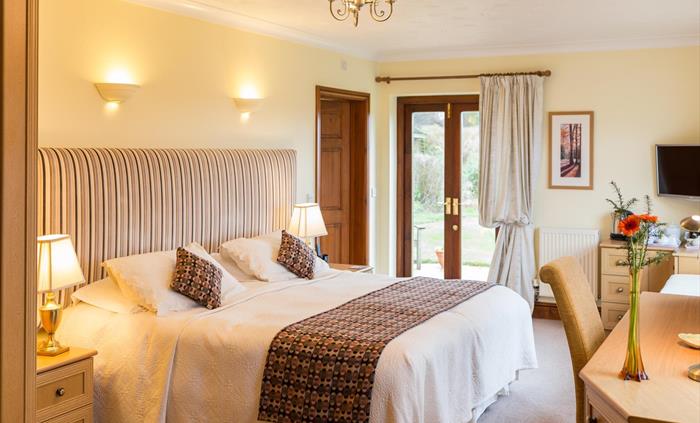 Carn Menyn Suite bedroom and access door to the garden.